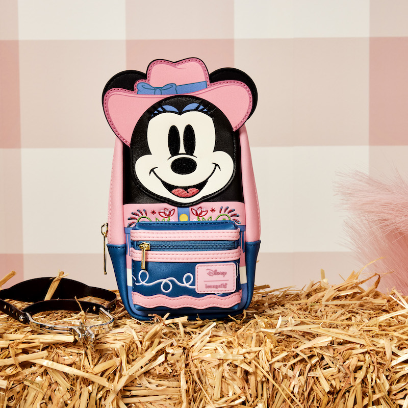 The Western Minnie Mouse Cosplay Stationery Mini Backpack Pencil Case sitting on a hay bale against a pink plaid background
